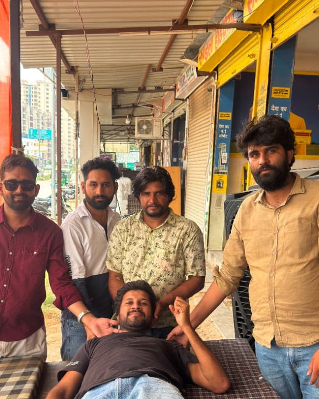 Volunteers standing with a blood donor resting after his donation at the Sikar Road camp in Jaipur
