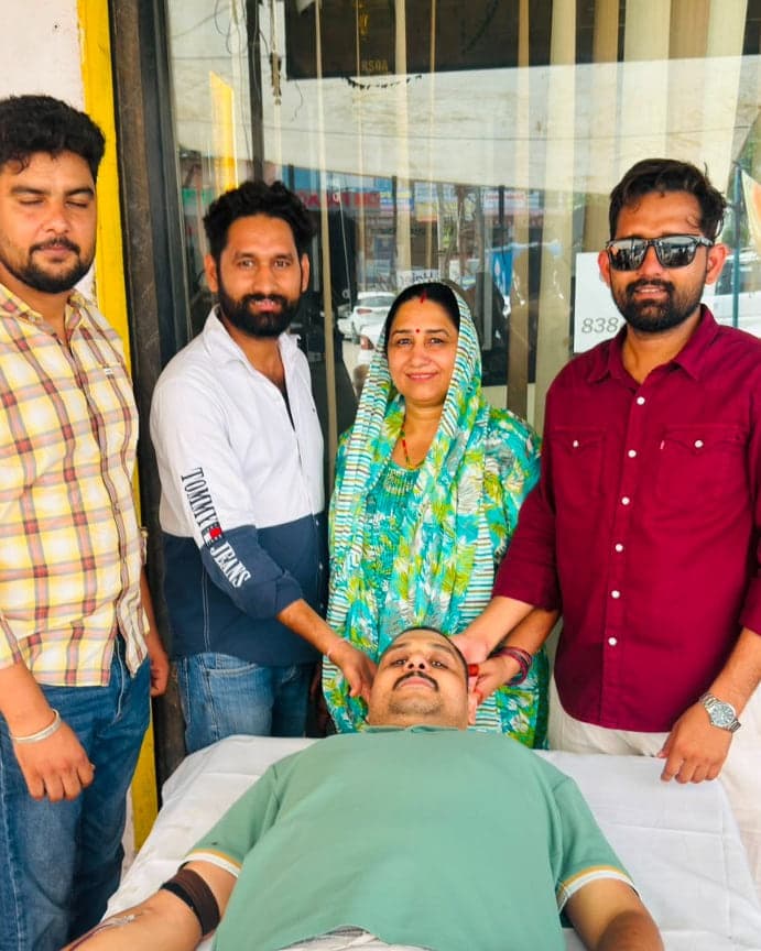 Woman from Badpipli village encouraging a blood donor at the Independence Day blood donation camp in Jaipur